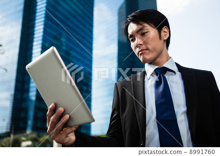 Businessman in the City using iPad Businessman in the City using iPad 8991760