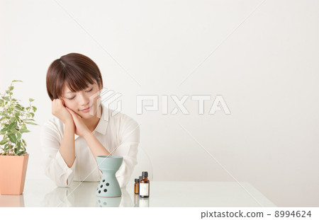 A woman enjoying aromatic oil A woman enjoying aromatic oil 8994624