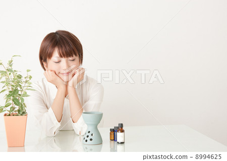 A woman enjoying aromatic oil 8994625