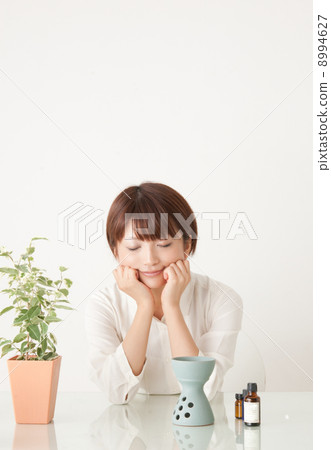 A woman enjoying aromatic oil A woman enjoying aromatic oil 8994627