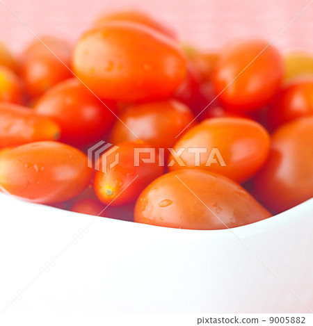 cherry tomatos in bowl on checkered fabric 9005882