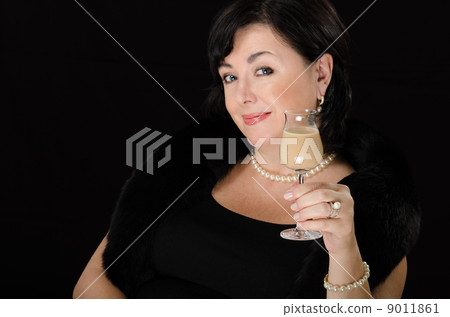 Woman with a glass of cream liqueur Woman with a glass of cream liqueur 9011861
