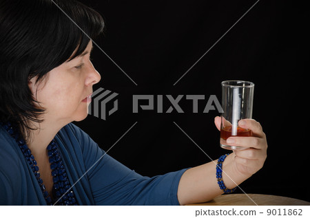 Alcoholic woman with glass of brandy Alcoholic woman with glass of brandy 9011862