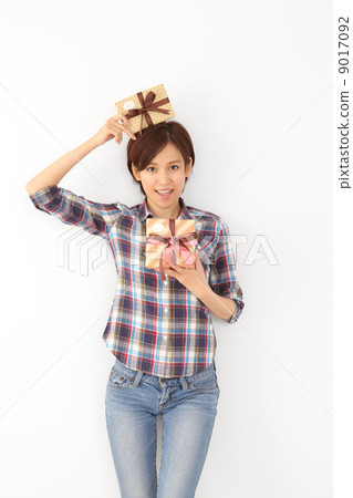 A woman putting a present on her head 9017092