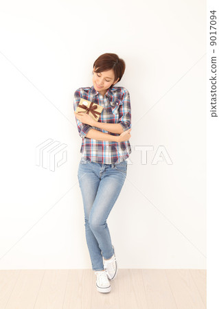 A woman holding a gift cherish 9017094