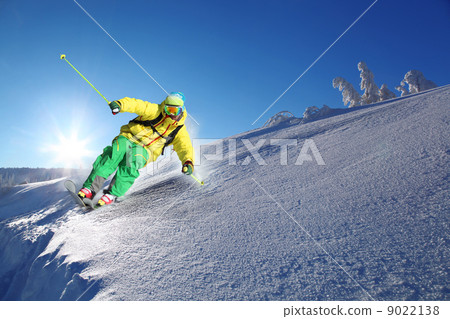 Skier skiing downhill in high mountains Skier skiing downhill in high mountains 9022138