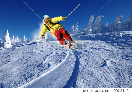 Skier skiing downhill in high mountains Skier skiing downhill in high mountains 9022143
