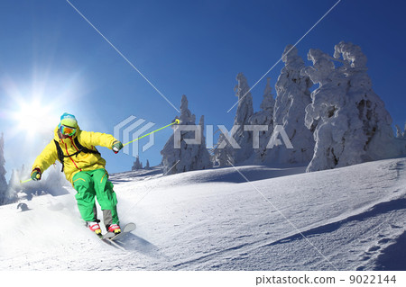 Skier skiing downhill in high mountains Skier skiing downhill in high mountains 9022144