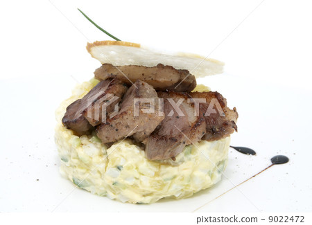 Olivier salad with meat on a white background in restaurant 9022472
