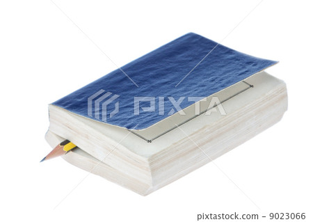 Pencil in a book on a white background. Pencil in a book on a white background. 9023066