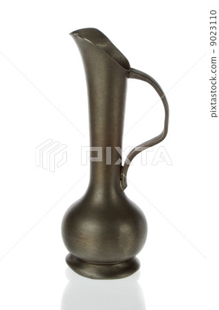 Antique brass pitcher, jug  on a white background. 9023110