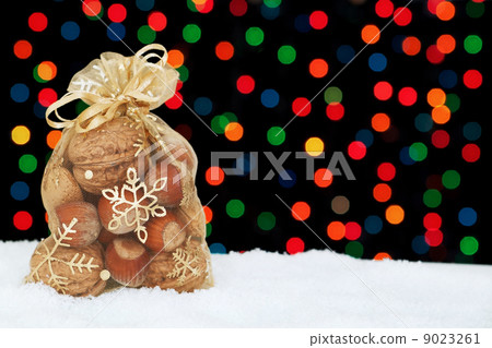 Christmas present in the snow on a background of colored bokeh. Christmas present in the snow on a background of colored bokeh. 9023261