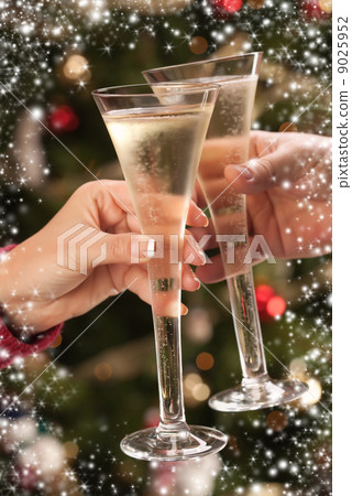 Man and Woman Toasting Champagne in Front of Lights Man and Woman Toasting Champagne in Front of Lights 9025952