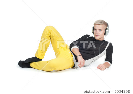 Man in headphones lying watching on you Man in headphones lying watching on you 9034598