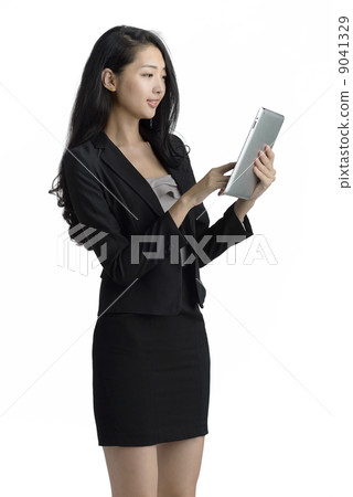 Young business woman using ipad digital tablet studio white background 9041329