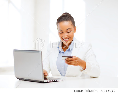 businesswoman with laptop and credit card businesswoman with laptop and credit card 9043059