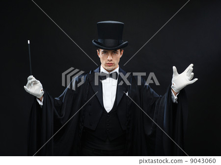 magician in top hat with magic wand showing trick magician in top hat with magic wand showing trick 9043060