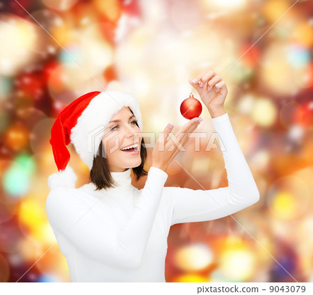 woman in santa helper hat with christmas ball 9043079