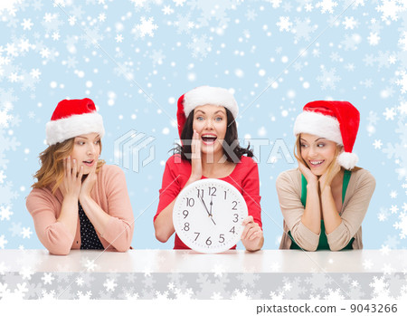 women in santa helper hats with clock showing 12 women in santa helper hats with clock showing 12 9043266