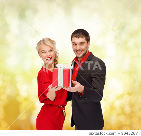 smiling woman and man with gift box smiling woman and man with gift box 9043267