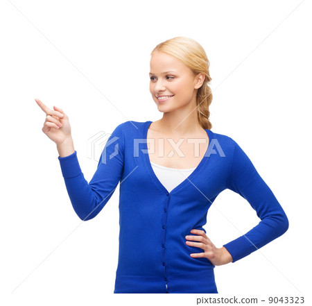 smiling woman in pointing her finger 9043323