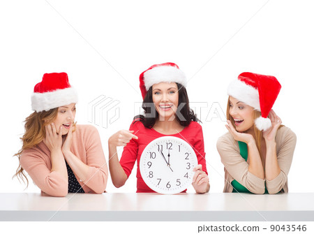 women in santa helper hats with clock showing 12 women in santa helper hats with clock showing 12 9043546