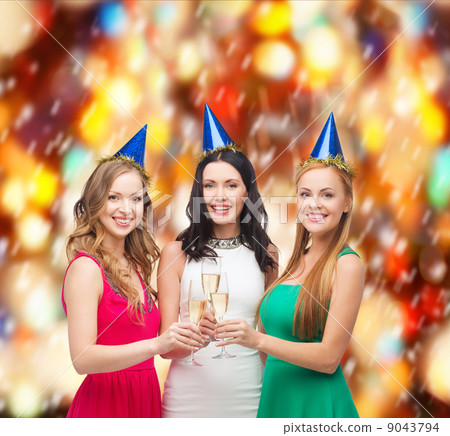 three women wearing hats with champagne glasses 9043794