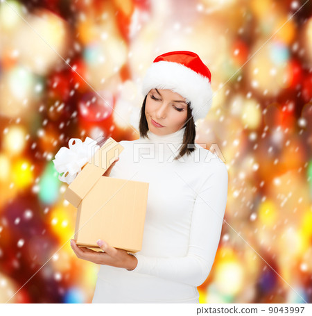 suspicious woman in santa helper hat with gift box 9043997