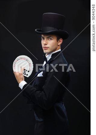 magician showing trick with playing cards 9044348