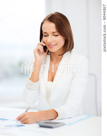 woman with papers, calculator and smartphone 9044867