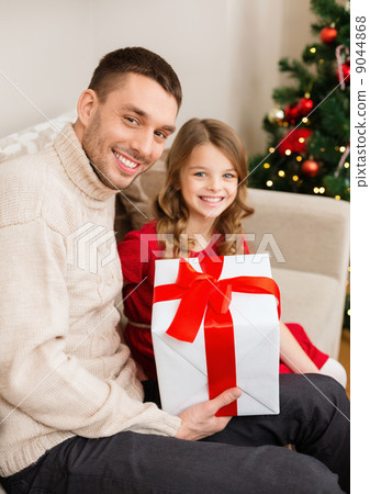 smiling father and daughter holding gift box 9044868