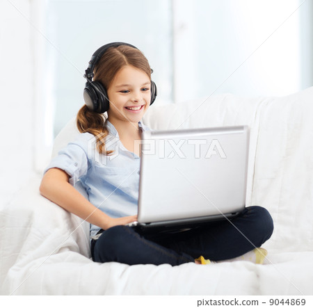 girl with laptop computer and headphones at home 9044869