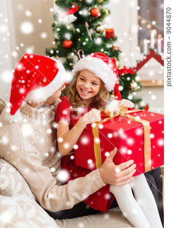 smiling father and daughter opening gift box 9044870