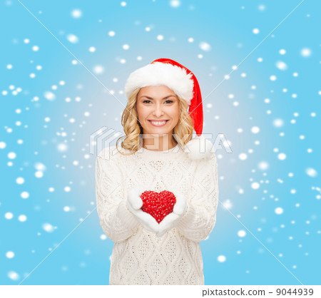 smiling woman in santa helper hat with red heart smiling woman in santa helper hat with red heart 9044939