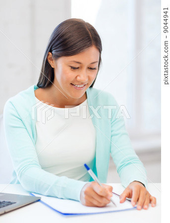 asian businesswoman with laptop and documents asian businesswoman with laptop and documents 9044941