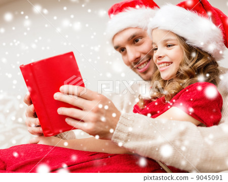 smiling father and daughter reading book smiling father and daughter reading book 9045091