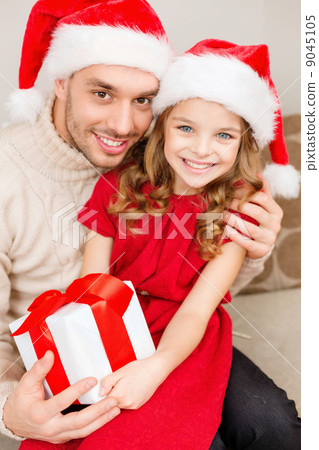 smiling father and daughter holding gift box 9045105