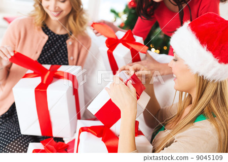 three women holding many gift boxes three women holding many gift boxes 9045109