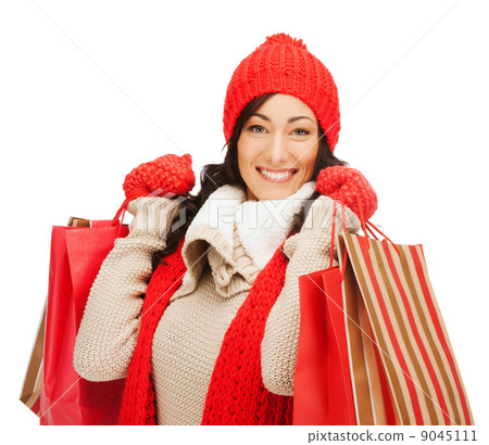 smiling woman in warm clothers with shopping bags smiling woman in warm clothers with shopping bags 9045111