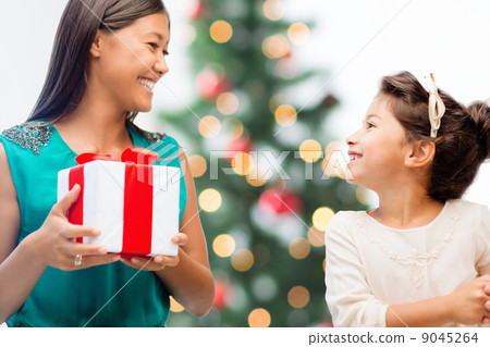 happy mother and child girl with gift box happy mother and child girl with gift box 9045264