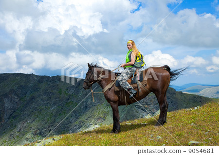 Female rider on horseback at mountains 9054681