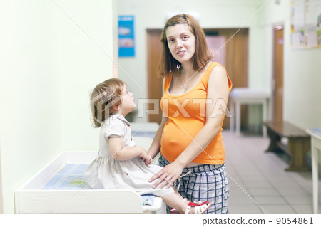pregnant woman with child  at the clinic 9054861