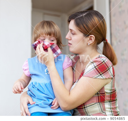 woman wipes snivels  daughter 9054865