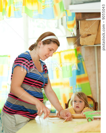 pregnant woman with child making dumplings 9055043