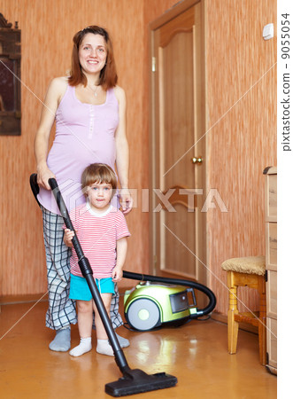 mother and daughter chores with vacuum cleaner mother and daughter chores with vacuum cleaner 9055054