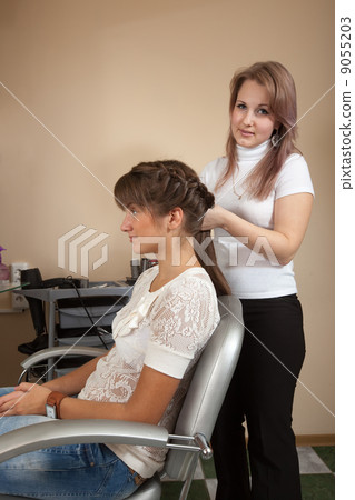Female hair stylist working with girl 9055203
