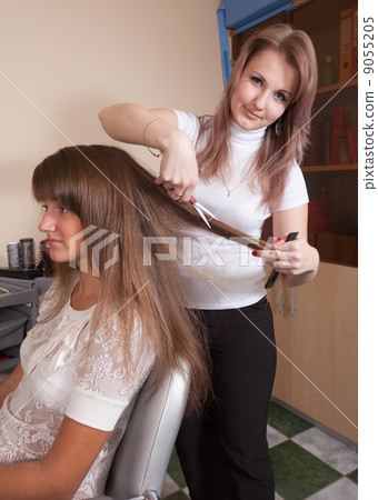 hairdresser working with long-haired girl 9055205