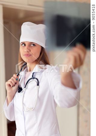 doctor looks x-ray results in clinic 9055418