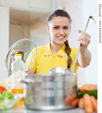woman cooking  in saucepan at home 9055482