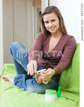 Beautiful girl cares for toenails Beautiful girl cares for toenails 9055510